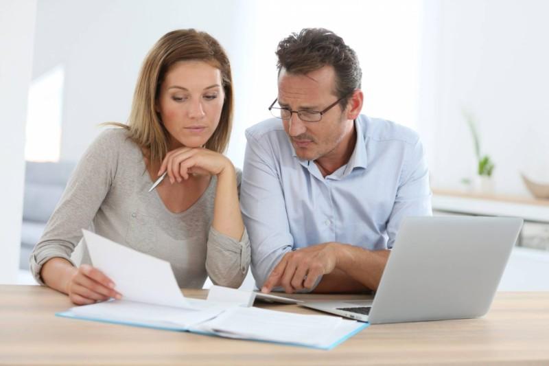 Two people checking their bills 